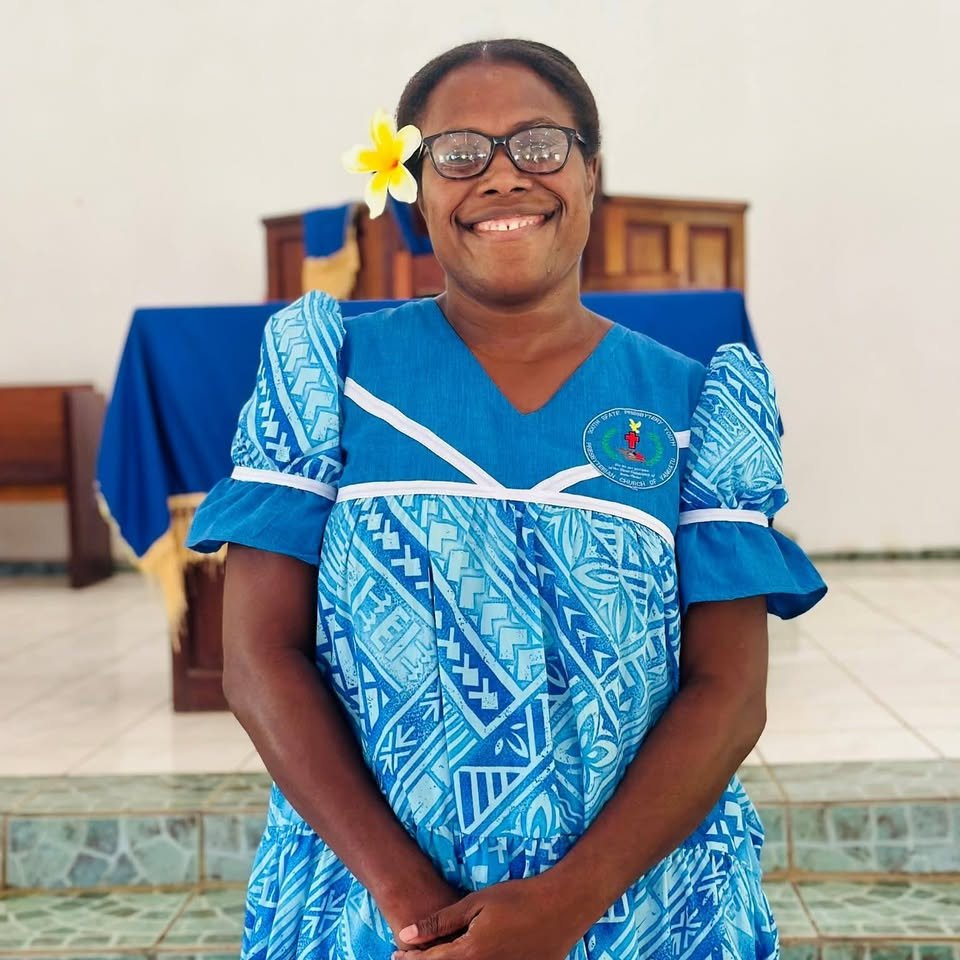 A young woman wearing a South Efate Presbytery Youth PCV badge